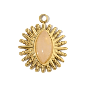 Detail of bohemian sunburst pendant with marquise pink stone and gold stainless steel