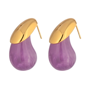 Macro detail of golden teardrop earrings with purple marble resin pendants