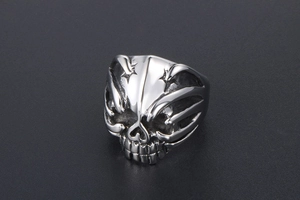 Detail shot of a gothic skull ring with vintage silver finish and punk rock metal texture