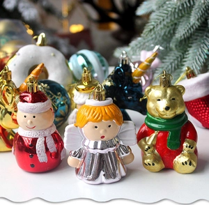 Macro view of assorted Christmas tree ornaments including red snowman and golden bear