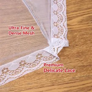 Rectangular mesh food cover with elegant white lace trim on a wooden table surface
