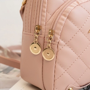 Pink quilted PU leather backpack with golden circular zipper puller and chic embroidery