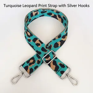 Detail of emerald green leopard print nylon bag strap with silver metal swivel hooks