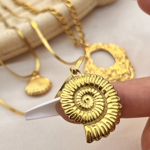 Golden stainless steel seashell pendant necklace set with elegant nautilus design
