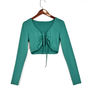 Detailed close-up of green long sleeve crop top with drawstring tie and knit texture