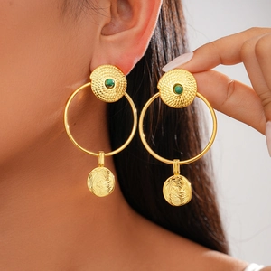 Close-up of 24K gold plated earrings featuring green stones and spiral textures