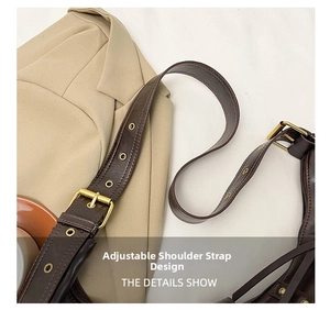 Detail showing the adjustable shoulder strap with gold buckle on a retro brown bag