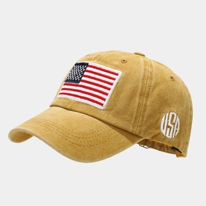 Detail view of mustard yellow vintage washed cotton baseball cap with USA flag patch