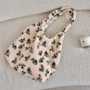 Close-up of soft plush floral tote bag with high-quality lamb wool texture and brand label