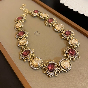 Detailed macro view of Baroque vintage necklace with purple and champagne gems
