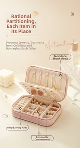 Pink velvet jewelry box detail showing necklace hooks and multi-functional inner compartments