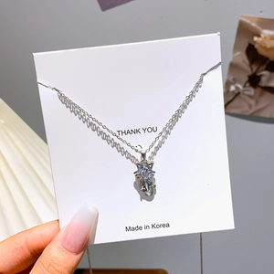 Silver kitten necklace with a round cubic zirconia pendant on a minimalist thin chain