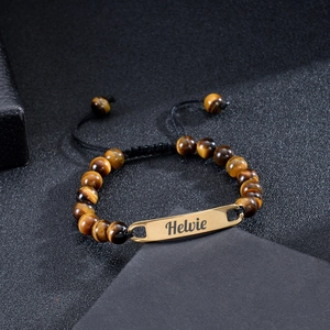 Close-up of Tiger Eye stone beads and golden metal nameplate on the custom bracelet