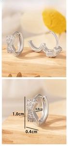 Detail view of silver bow earrings with zircon stones and 1.0cm outer diameter size info
