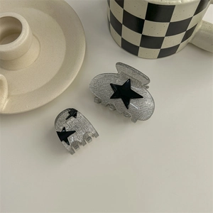 Y2K style silver glitter hair claw clip set with black star patterns on white background