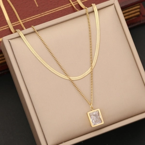 Double layered gold stainless steel necklace featuring a square white crystal pendant