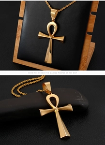 Detailed view of polished golden Ankh cross pendant with stainless steel twist chain