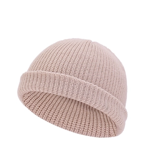 Close-up of beige docker hat showing thick knit texture and retro rolled brim design