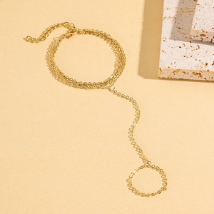 Detailed view of triple-layered gold slave bracelet with turquoise and pearl charms