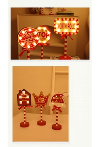 Close-up of LED Christmas STOP signs with festive red bows and warm holiday lighting
