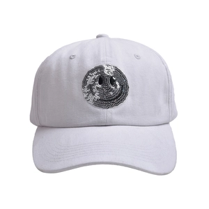 Detail of silver sequin smiley face patch on white washed cotton baseball cap