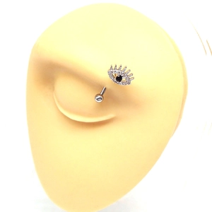 Detail view of heart-shaped devil eye curved barbell piercing on a silicone model