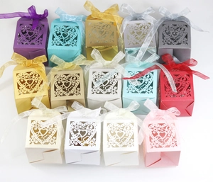 Detail of laser-cut heart pattern gift boxes with satin bows in various colors
