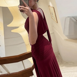 Close-up of wine red bodycon dress with backless design and elegant ruching detail