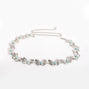 Detail of silver butterfly metal waist chain with light blue turquoise stone accents