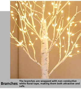 Detail of warm white LED lights on a decorative birch tree with realistic bark texture