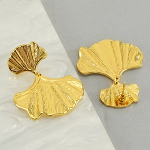 Elegant gold ginkgo leaf earrings in brushed stainless steel with textured finish