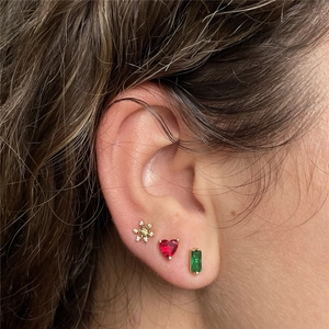Detailed close-up of gold snowflake, red heart, and green rectangle stud earrings set
