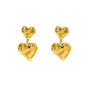 Detail of 18K gold double heart earrings featuring a modern molten lava textured finish