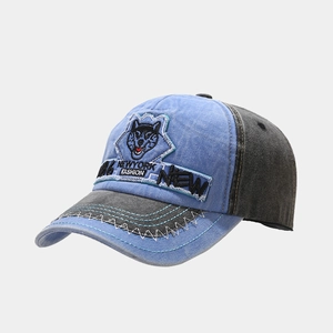 Detail of vintage husky patch embroidery and sawtooth stitching on a washed denim baseball cap