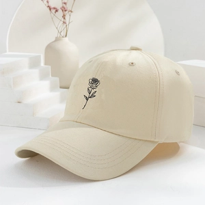 Detailed embroidery of a black rose on a premium beige cotton canvas baseball cap