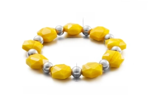 Detail of yellow faceted crystal beads and silver stainless steel beads on stretch bracelet