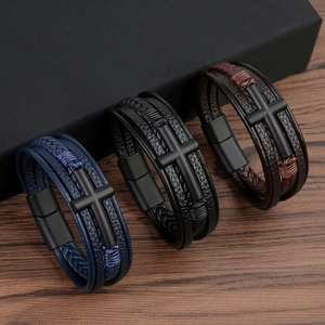 Close-up of woven leather bracelets with matte black cross charms and magnetic clasps