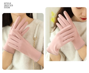 Detail view of pink thermal gloves with stitching accents and soft velvet lining