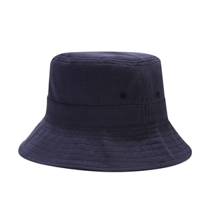 Detail of navy blue cotton bucket hat featuring reinforced stitching and breathable eyelets