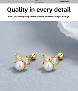 Detailed macro view of S925 silver bow earrings with round pearls and heart-shaped zircon
