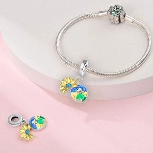 Macro detail of silver beaded bracelet with sunflower charm and colorful enamel pendant