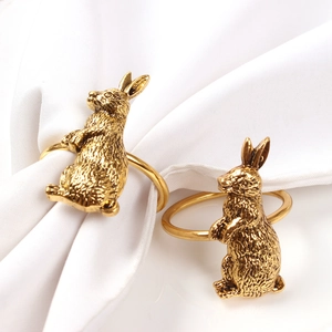 Detail of golden rabbit napkin rings with textured fur and antique brushed finish