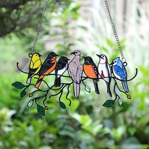 Colorful stained glass bird window hanging with seven artistic birds on a branch