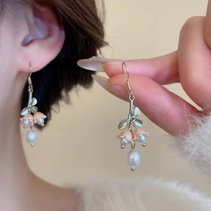 Detail showing elegant lily of the valley earrings with resin petals and drop pearls