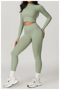 Sage green high-waist yoga set with thumb holes and half-zip top shown on model