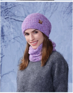 Detailed close-up of purple knit beanie and neck warmer set with leather logo patch