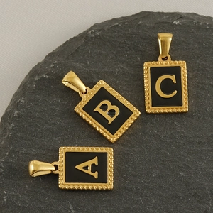 Golden stainless steel rectangle letter pendants with black enamel finish and beaded edges