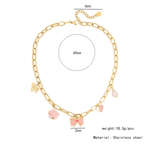 Detail of a gold stainless steel necklace featuring pink flower and butterfly charms