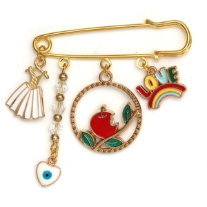 Detail of gold safety pin brooch featuring enamel charms like dress, apple and love rainbow