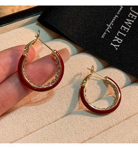 Macro shot of 14K gold plated red enamel hoop earrings with sparkling crystal accents